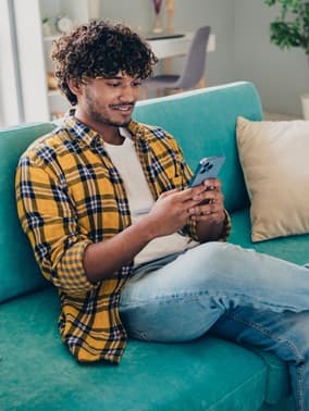 Person on a couch using a smartphone